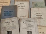 several old books sitting on top of a table next to each other