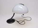 white table lamp with a black base and a black cord