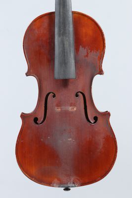 a close up of a violin on a stand against a white background