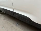 a close up of a white car with a black stripe on the side of it