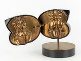 pair of gold and black cuff earrings with a horse and rider on them
