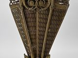 an antique brass vase with a decorative design on the top of it