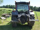 a tractor that is parked in the grass
