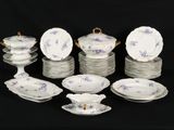 a lot of plates and bowls that are on a table