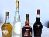 several bottles of alcohol are lined up on a marble table