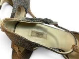 two pairs of women ' s shoes are shown on a white surface