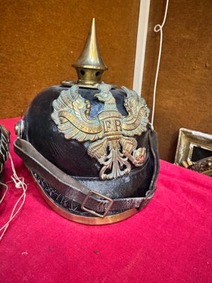 a helmet on a red cloth with a gold eagle on it