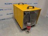 a yellow machine sitting on top of a floor next to a wall