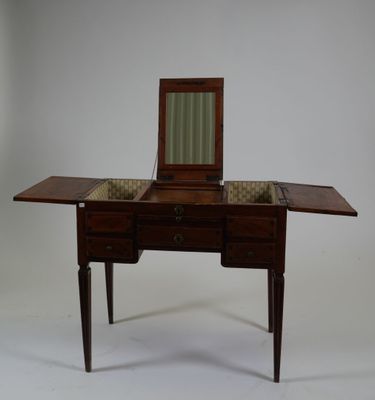 a small wooden table with a mirror on top of it