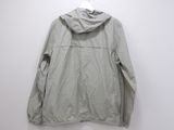 an image of a light gray jacket hanging on a white wall