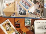 a suitcase full of stamps and stamps sitting on a table