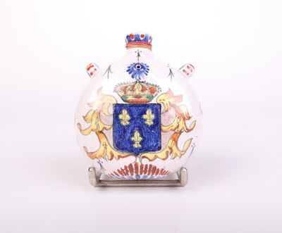 a glass vase with a coat of arms on it