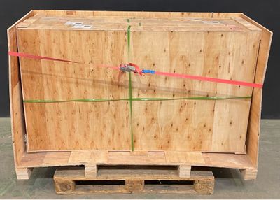 a large wooden box with a red ribbon on it