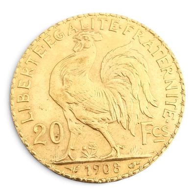 une image représentant une pièce d'or sur laquelle figure un coq couché sur le côté