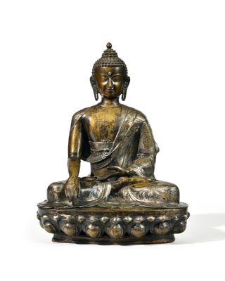 statue of a seated buddha on a lotus - shaped base