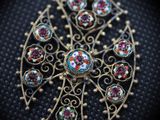 a close up of a broochle on a black surface