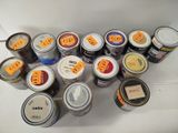 many cans of paint on a table with labels on them