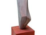 sculpture of a face on a wooden base on a white background