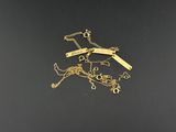 a close up of a bunch of gold necklaces on a black surface