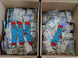 two boxes filled with lots of money sitting on top of a table