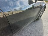 a black car parked on the side of the road
