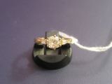 an image of a diamond ring on a black stand