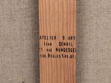 a close up of a wooden cross with a quote on it