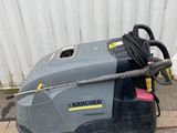 a close up of a machine on the ground near a building