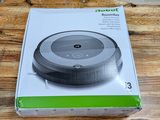 packaging for a robot vacuum cleaner on a wooden table