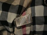 a checkered shirt that has a tag on it