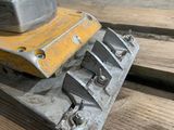 an image of a close up of a machine that is on a piece of wood