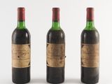 three bottles of wine sitting next to each other on a white surface