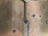 a close up of a brass clock with a metal handle