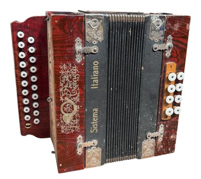 an image of a red and black accordion sitting on top of a white surface