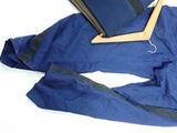 a blue suit and a book on a white surface