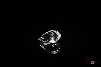 a close up of a diamond on a black surface