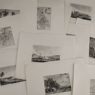 several black and white pictures of a bunch of buildings on a table