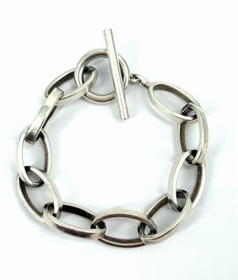silver bracelet with a bar in the middle of the link