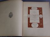 an open book with a picture of a coat of arms on it