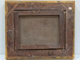 an old wooden picture frame with a brown canvas on a white surface