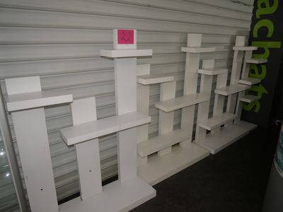a white shelf with a pink sticker on top of it