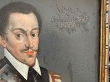 portrait of a man with a mustache in a suit of armor