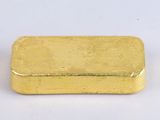rectangular gold plated metal container on a white surface