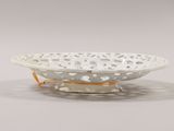 a close up of a white bowl on a stand on a table