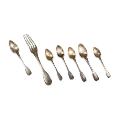 six silver spoons and a fork are lined up on a white surface