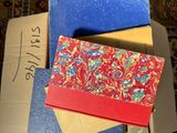 a box full of different colored envelopes on the floor