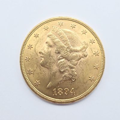 une image d'une pièce d'or sur une surface blanche