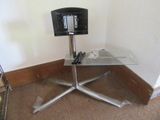 a glass table with a tv on top of it