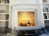 a picture of a fireplace in the corner of a living room