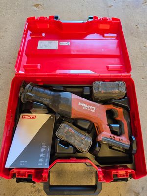 a red tool box with tools in it on the floor
